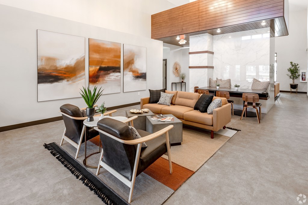 a living room with a couch and chairs and a table