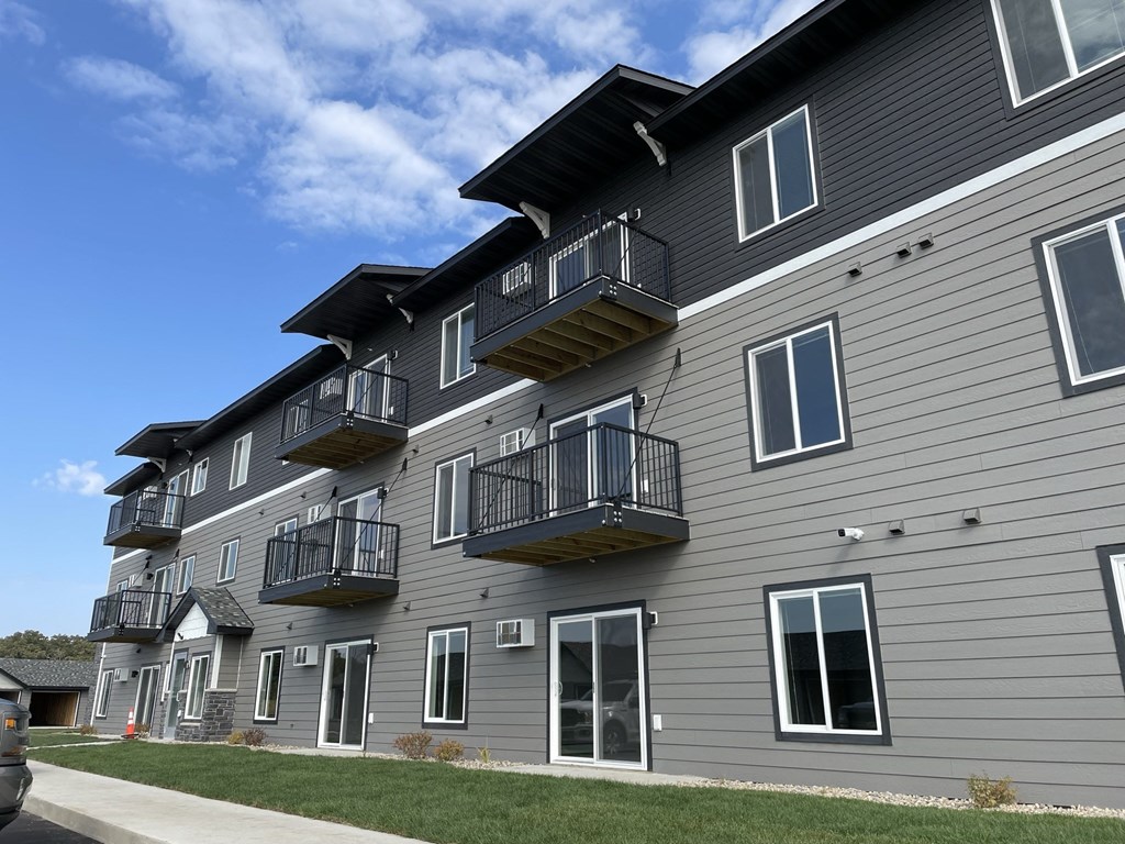 the exterior of an apartment building with balconies