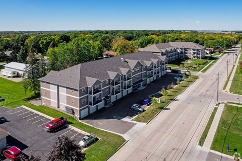 A large building with a parking lot in front of it.
