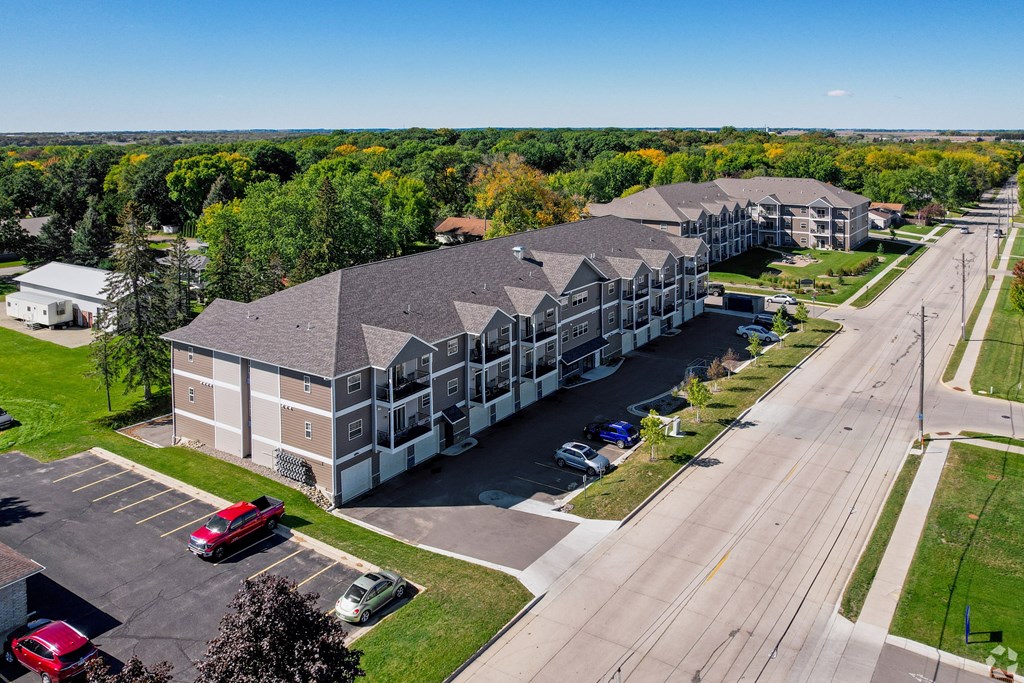 A large building with a parking lot in front of it.