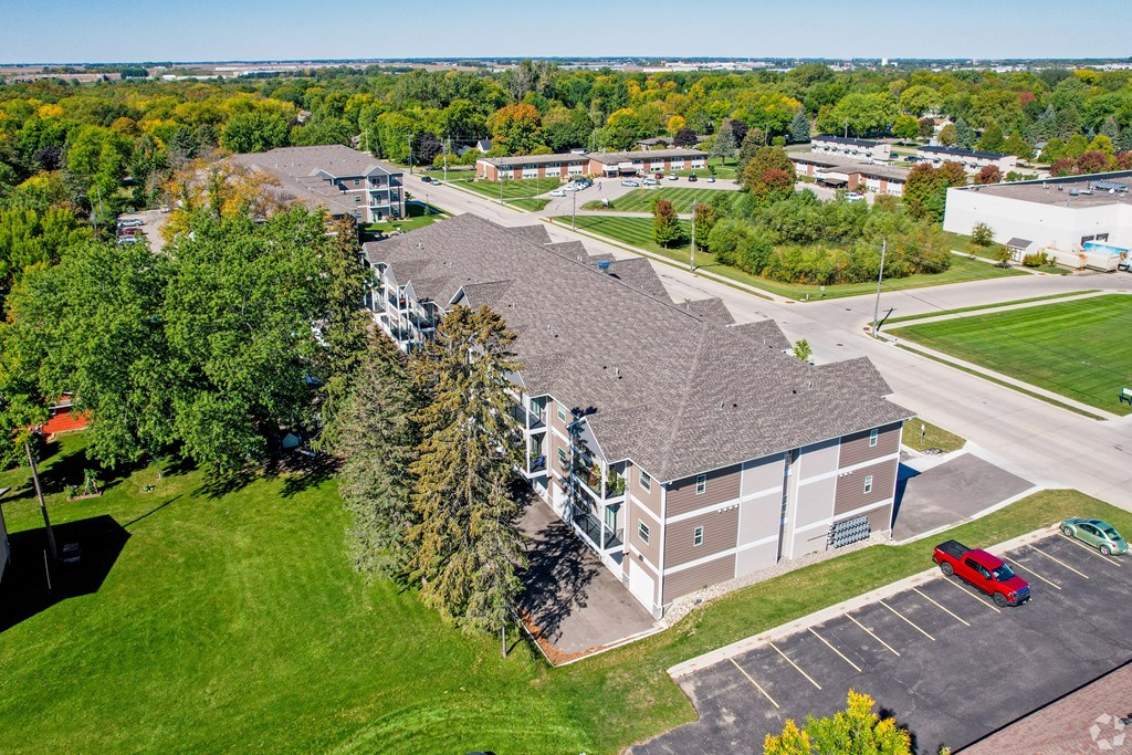 A large building with a parking lot in front of it.