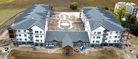 A large building complex with a playground in the middle.