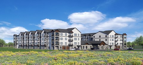A large, modern apartment building with a grassy field in front.