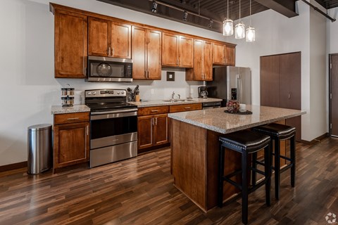 a kitchen with wooden cabinets and stainless steel appliances