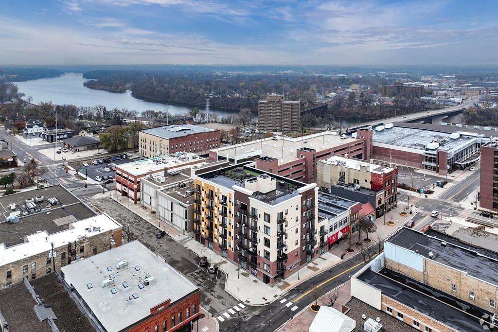 an aerial view of a city with buildings and a river