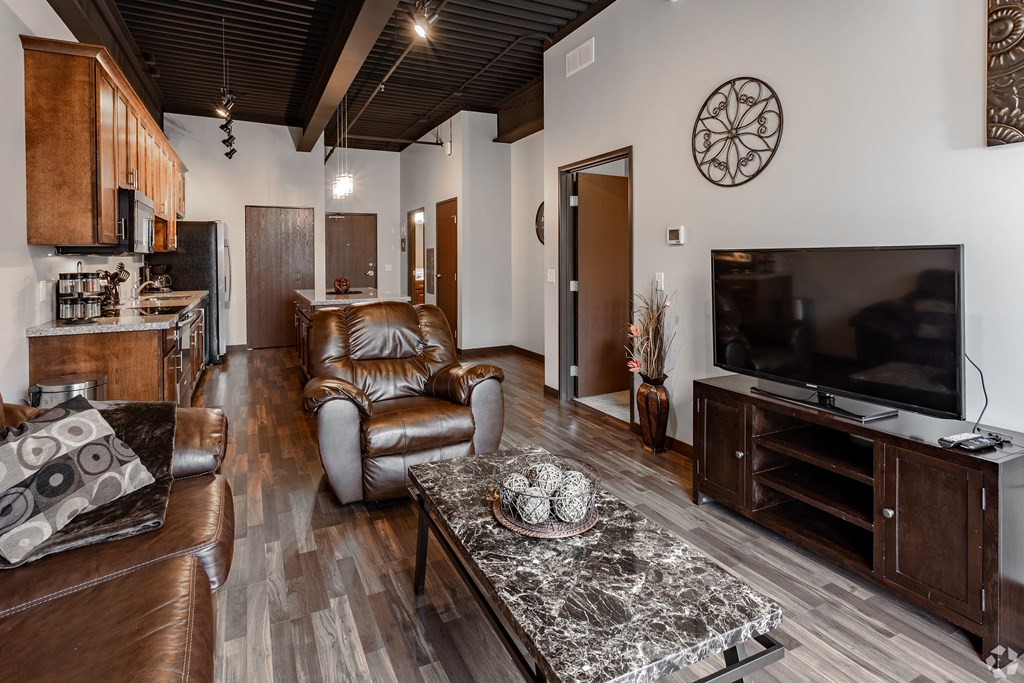 a living room with leather furniture and a tv