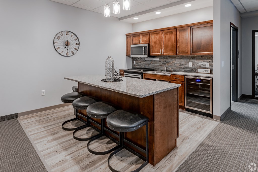 a kitchen with a center island with four stools