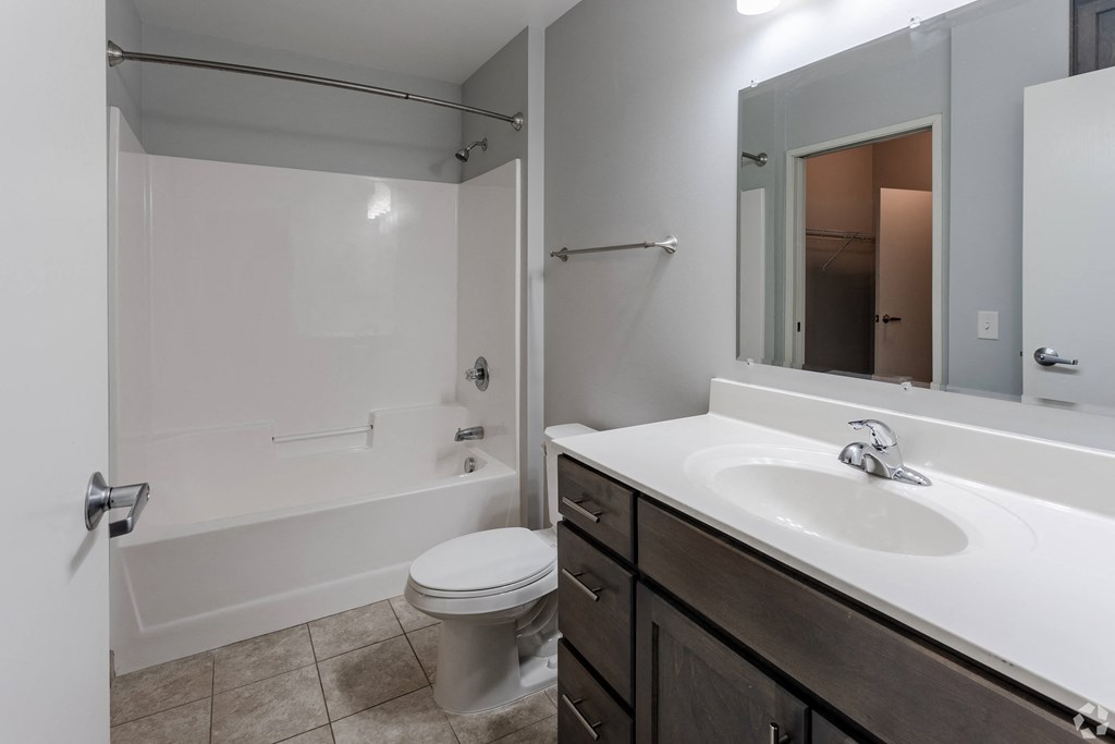 an empty bathroom with a sink toilet and shower