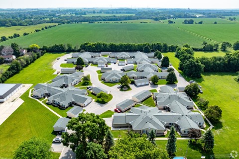 A bird's eye view of a residential area with houses and greenery.