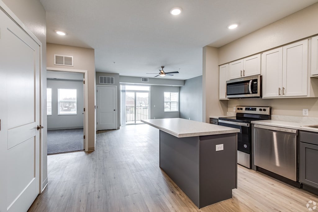 A kitchen with a stove, oven, and microwave.