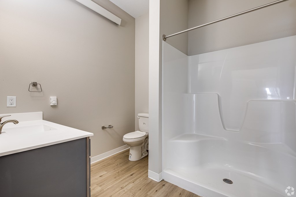 A white sink and toilet in a small bathroom.