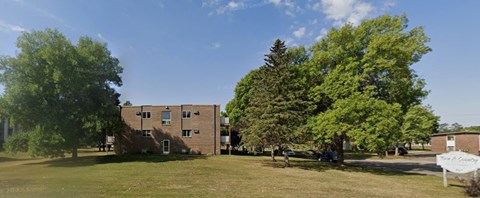 A building with a green lawn in front of it.
