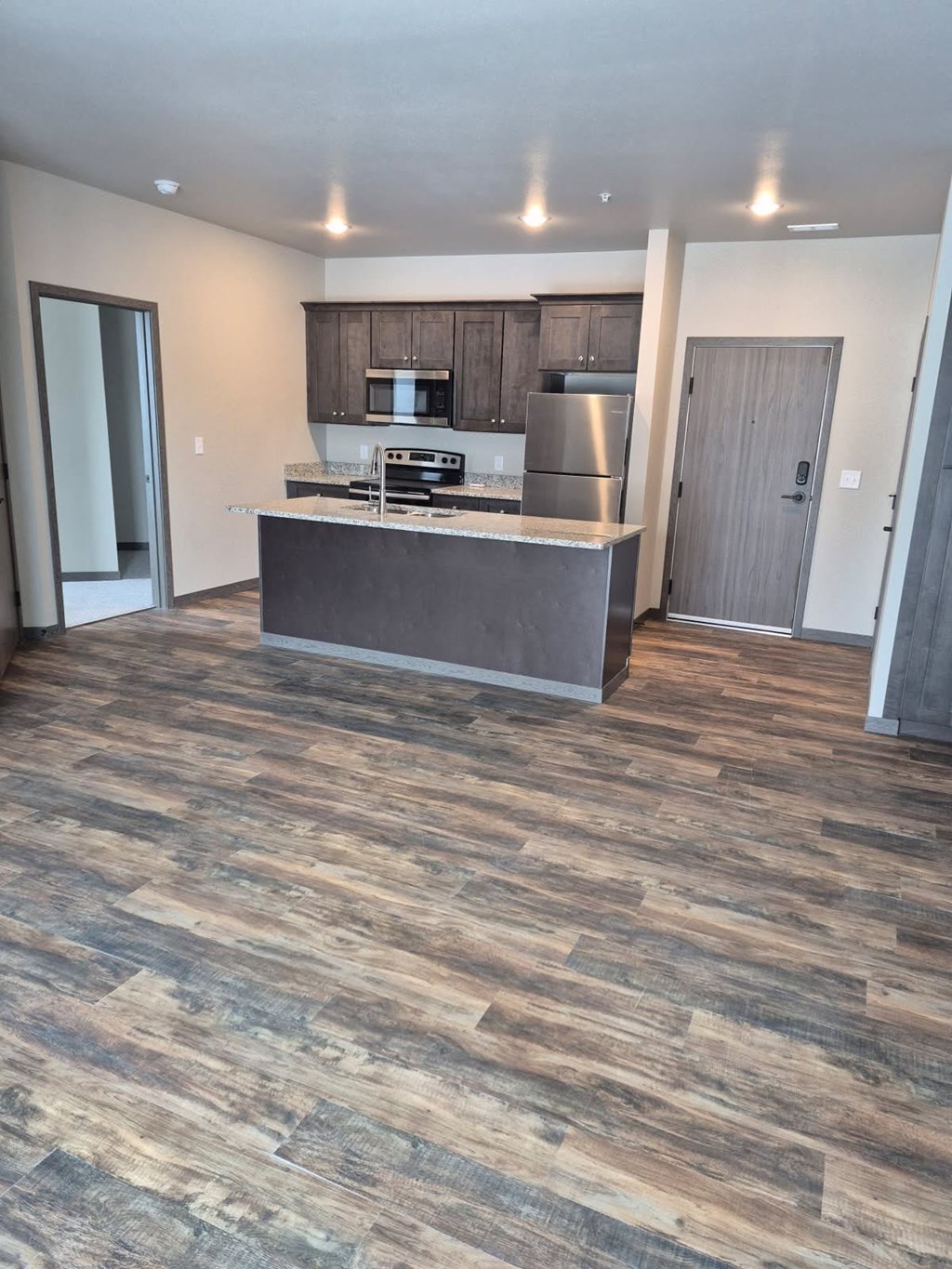 A kitchen with a wooden floor and a countertop.