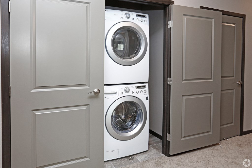 a front loading washer and dryer in a closet