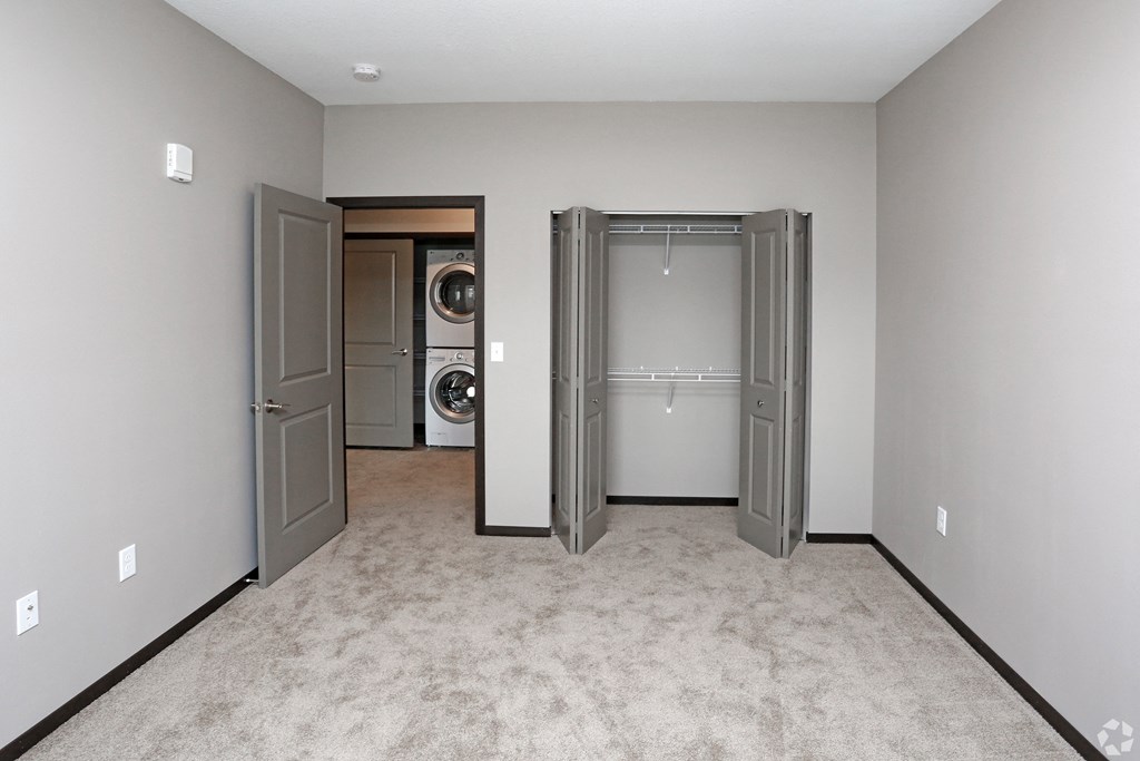 a laundry room with two doors and a washer and dryer