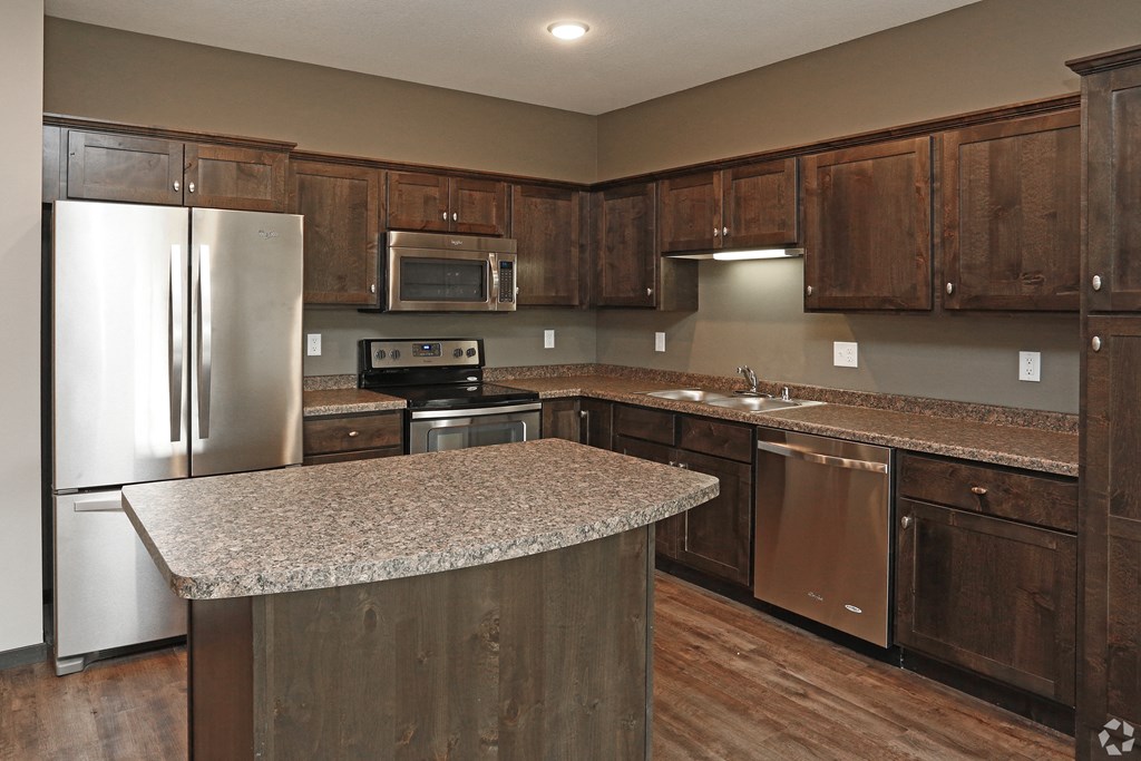 a kitchen with stainless steel appliances and granite counter tops