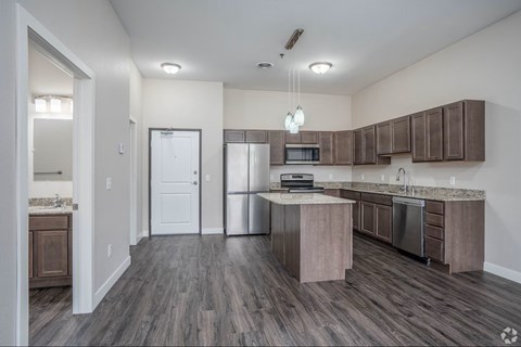 A kitchen with a white door and a counter.