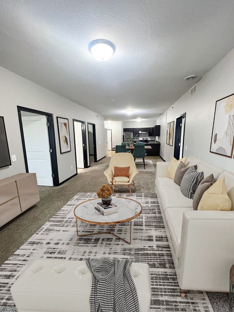A living room with a white couch and a coffee table.