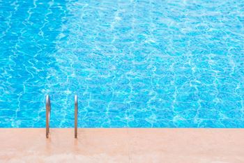 a swimming pool with two plungers on the side of it