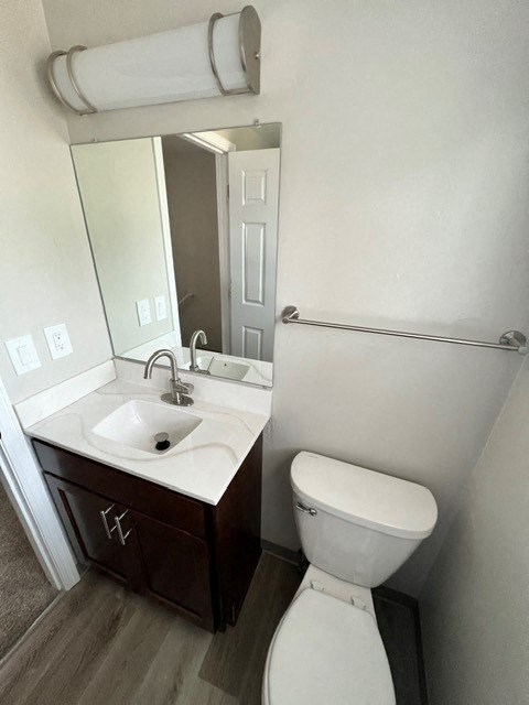 a bathroom with a toilet sink and a mirror