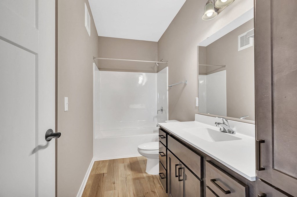 A bathroom with a white sink and a walk-in shower.