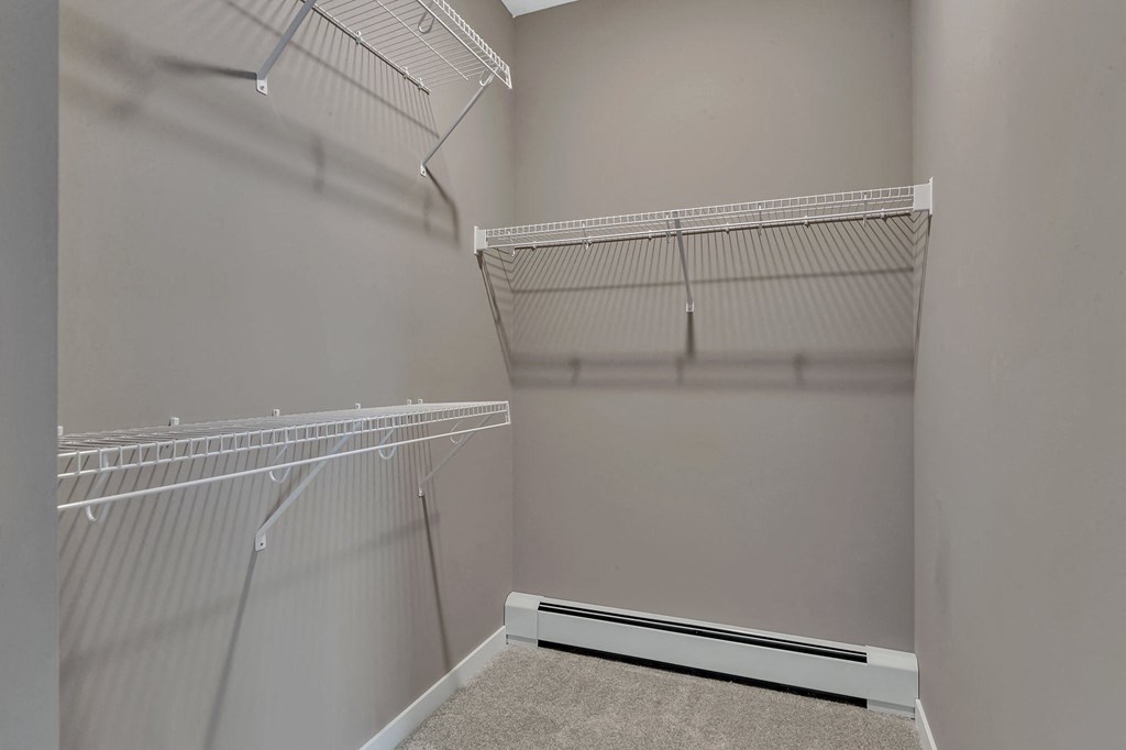 Empty white shelves in a room.