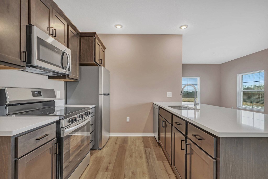 A kitchen with a stove top oven and microwave.
