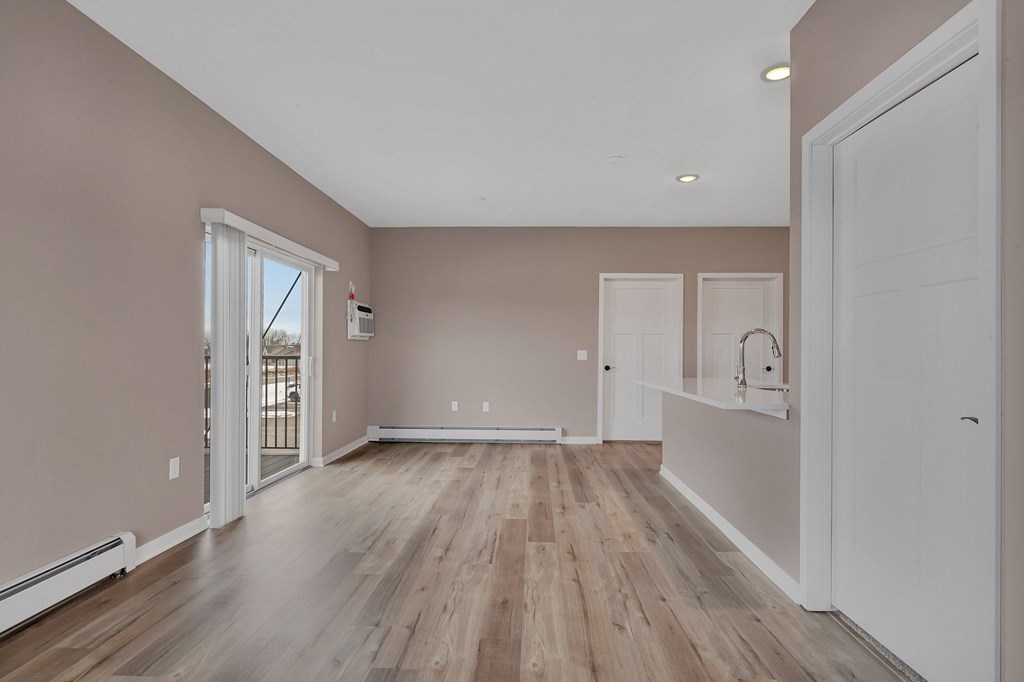 A room with wooden floors and white walls.