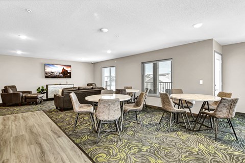 a community room with tables and chairs and a couch