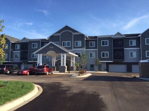 an apartment building with cars parked in front of it