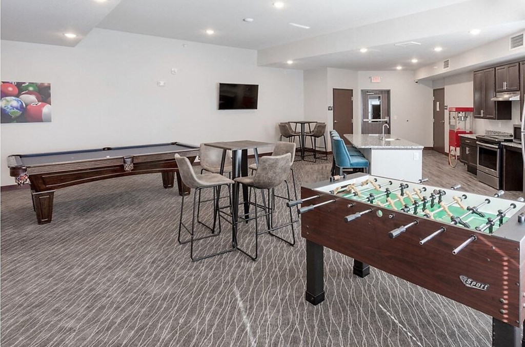 a game room with two pool tables and a bar