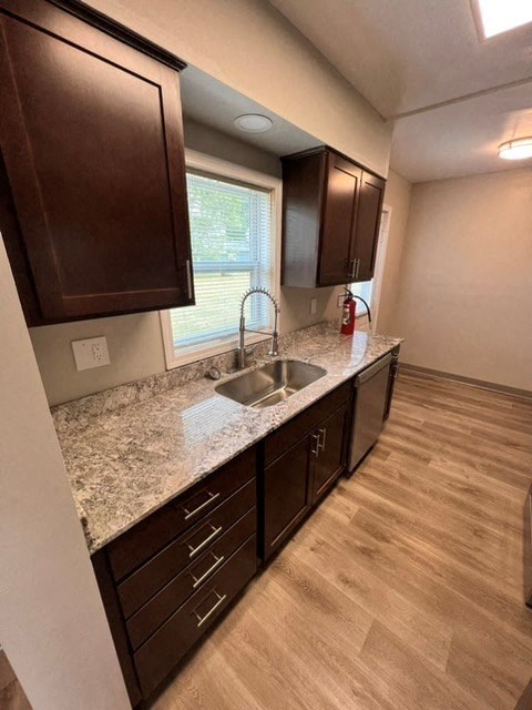 a kitchen with a sink and cabinets and a window