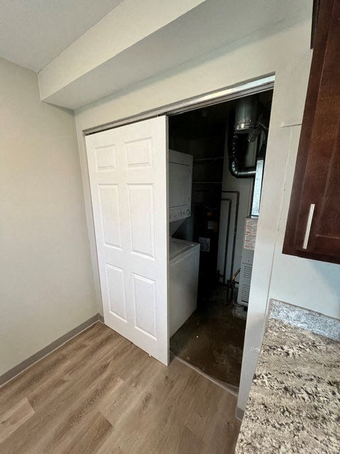 a closet with a white door and a wood floor