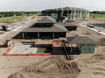 an aerial view of a building under construction in a parking lot