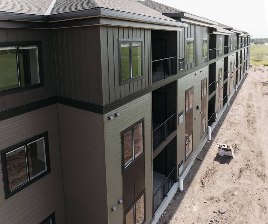 a view of a building from the top of a hill