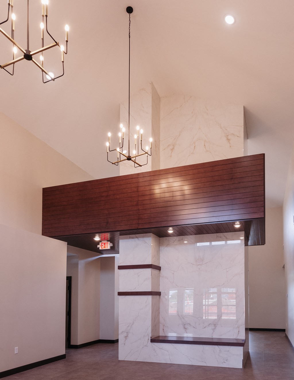 a large lobby with a marble pillar and chandeliers