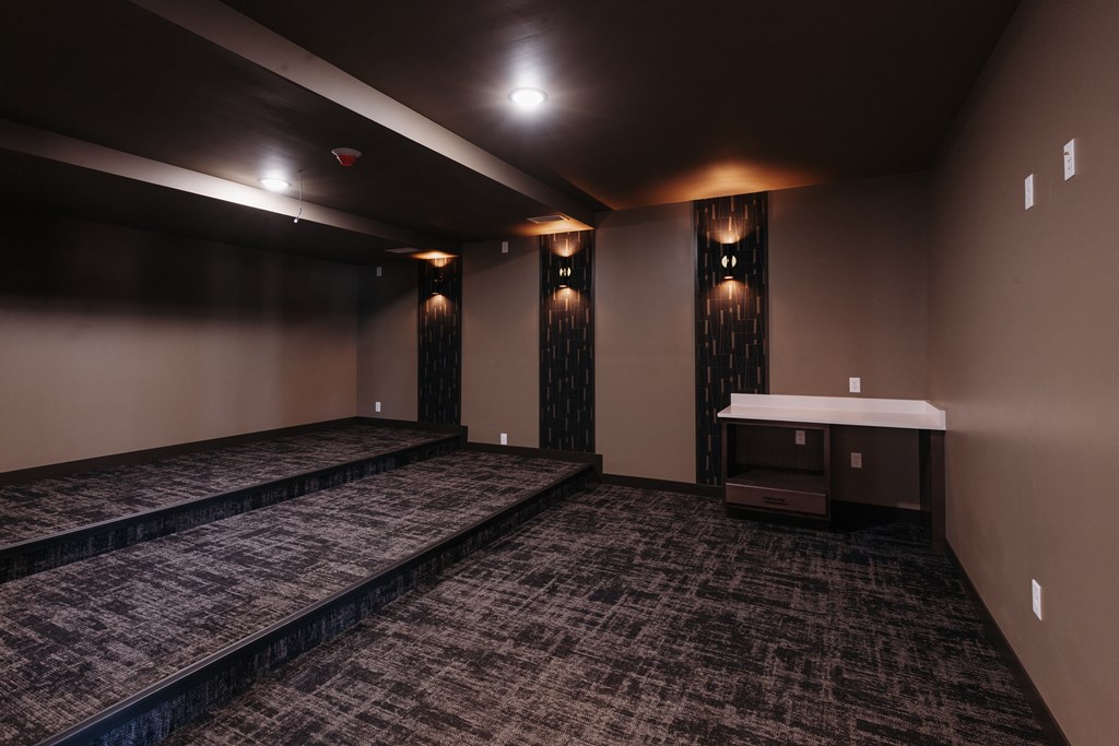 a dark room with a couch and a table