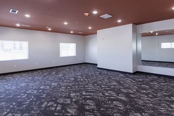 a large empty room with white walls and a carpeted floor
