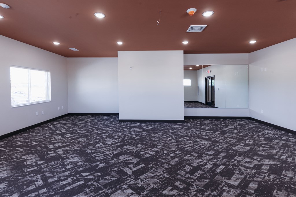 an empty room with a white wall and a window