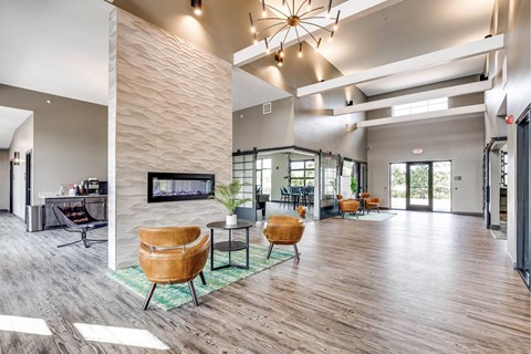A modern living room with a fireplace and wooden floors.