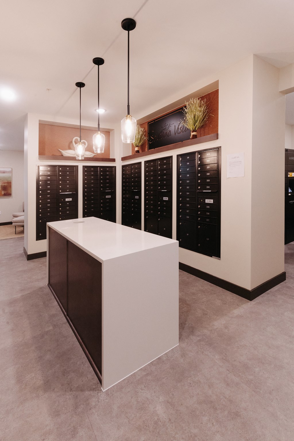 a wine tasting room with a white island in front of a rack of wine bottles