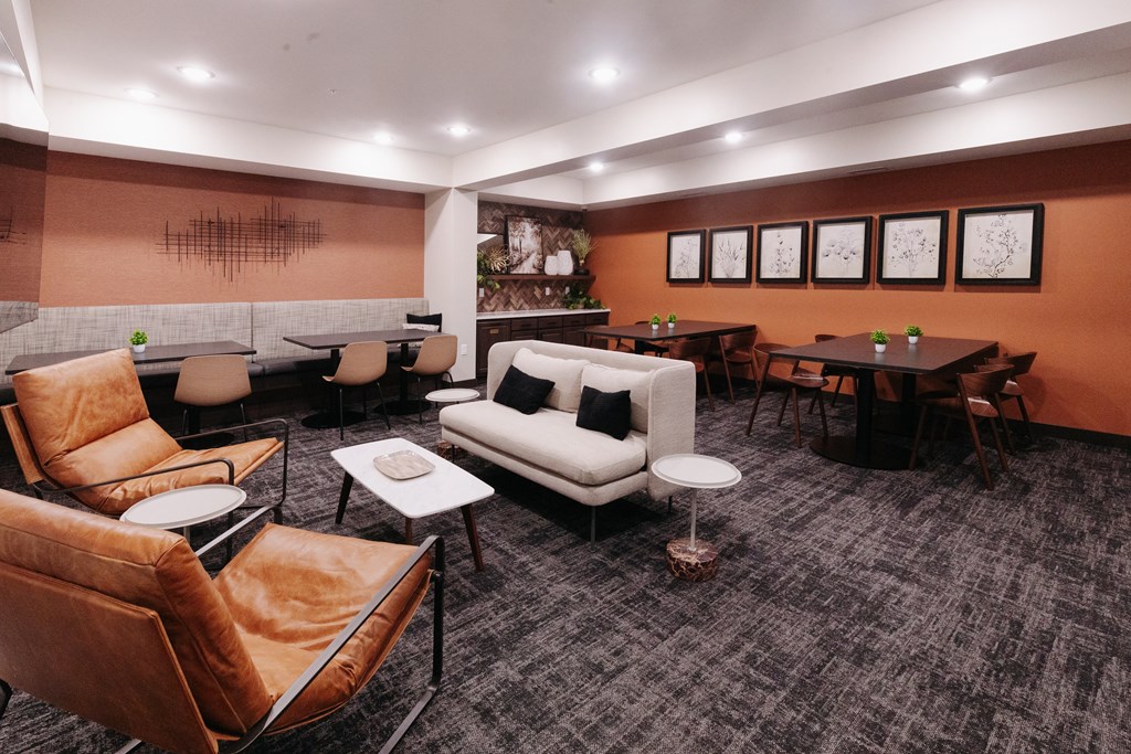 a lounge area with couches and chairs and tables