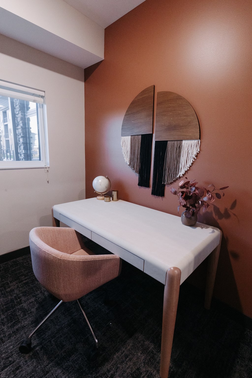 a desk and chair in a room with a mirror
