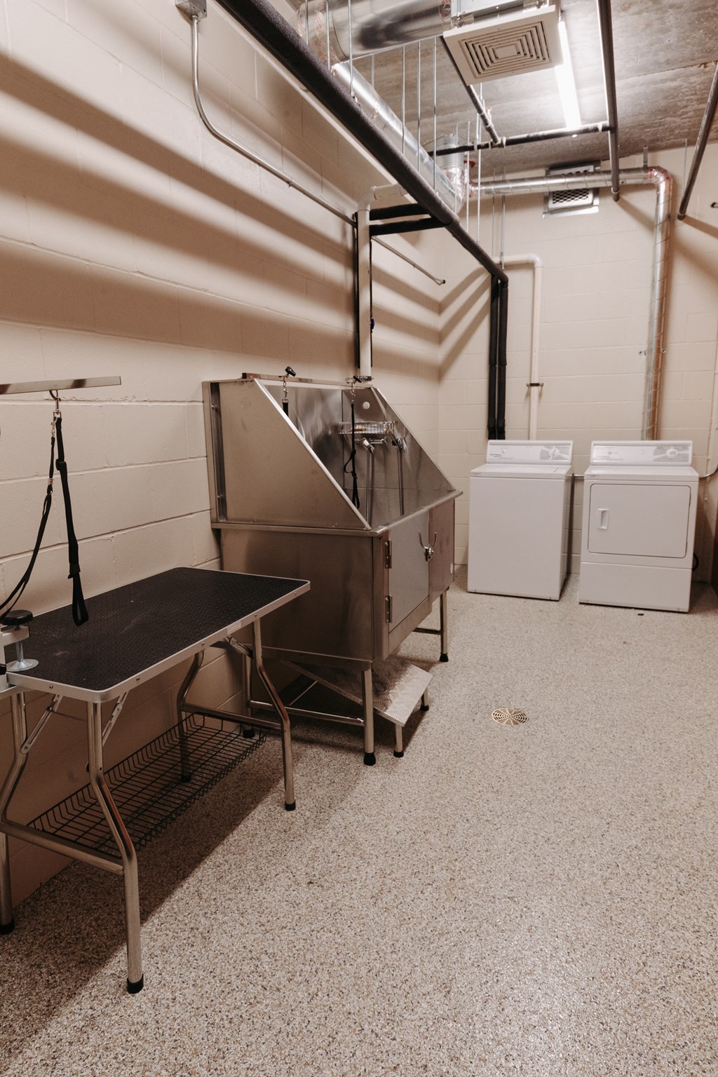 a large stainless steel machine in a room with other appliances