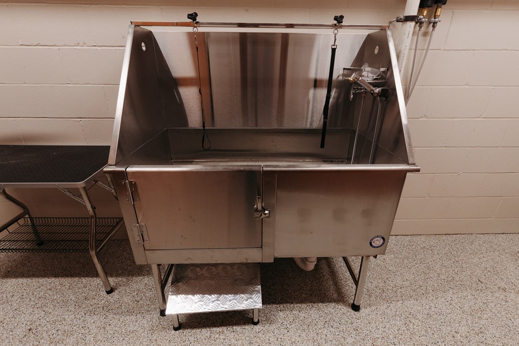 a stainless steel food truck is parked in front of a wall