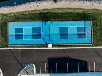 an aerial view of an empty tennis court with a blue court