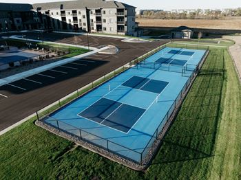 an aerial view of the tennis court at the resort