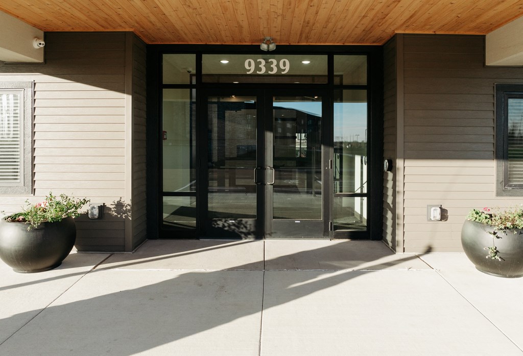 the front entrance of a building with glass doors