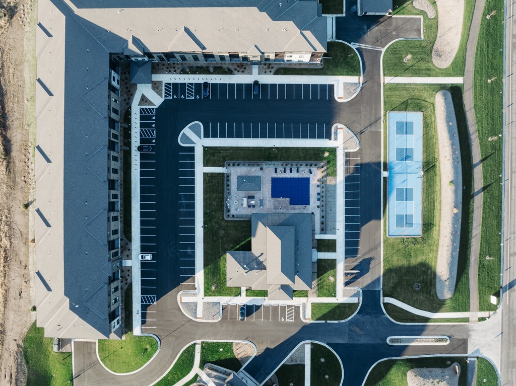 an aerial view of a building on top of a parking lot