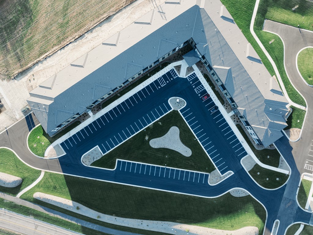 an aerial view of a large building with a football field on the roof